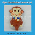 Ceramic souvenir fridge magnet with monkey figurine